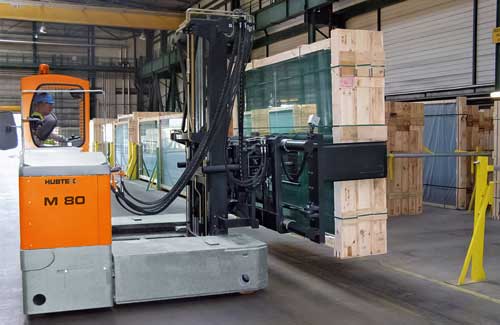 Hubtex multidirectional sideloader carrying a glass pack in a glass production facility