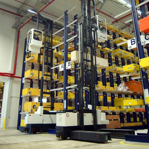 Hubtex electric multidirectional sideloader storing airplane parts in a cantilever rack system